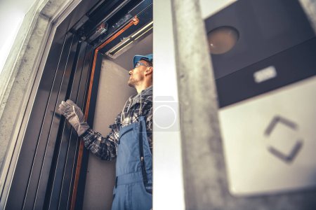 Photo for New Residential Building Elevator Installation. Final Checks Performed by Professional Elevator Systems Technician in His 40s. - Royalty Free Image