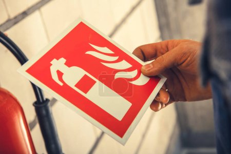 Photo for Closeup of Fire Safety Label Illustrating Extinguisher Sign for Equipment Placement Indication. - Royalty Free Image