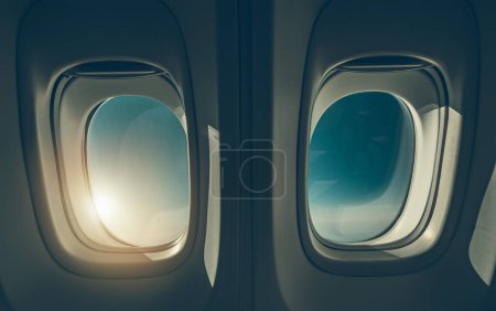 Téléchargez les photos : Two Airplane Windows and the Sunlight. Air Travel Theme. - en image libre de droit