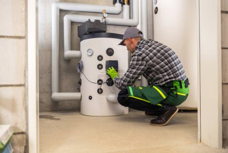 Téléchargez les photos : Caucasian HVAC Technician in His 40s Finishing Installation of Residential Gas Heating Boiler. - en image libre de droit
