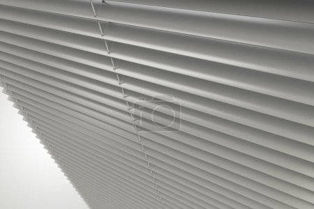 Horizontal Slats Classic White Plastic WIndow Blinds 3D Rendered Illustration. Residential and Commercial Window Covers