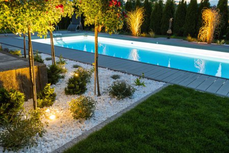 Foto de Scenic Residential Outdoor Swimming Pool Illuminated by LED Lighting. Poolside Surrounding Theme. - Imagen libre de derechos