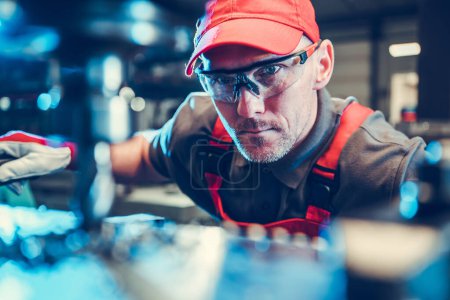 Photo for Caucasian Milling or Lathe Machine Operator in His 40s Wearing Safety Glasses. Metalworking Industry Theme. - Royalty Free Image