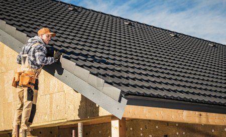 Téléchargez les photos : Black Ceramic House Tiles Roof Construction Theme. Contractor Roofer Checking on Finished Building Roof. - en image libre de droit