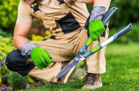 Photo for Caucasian Professional Garden and Landscape Worker with Large Manual Hedge Trimmers in His Hands - Royalty Free Image