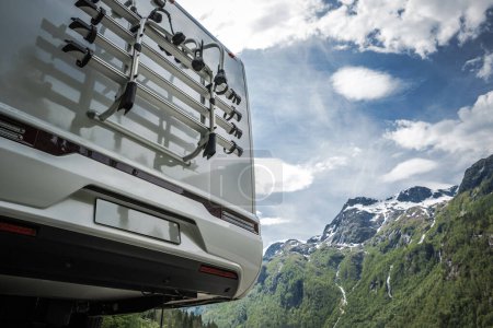Photo for Modern Half Integral Camper Van on the Road Trip. Rear View with Scenic Mountains in a Background. Bike Rack Close Up. - Royalty Free Image