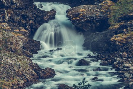 Foto de Escenic View of Tumbling Waterfall Running Through Rocky Mountains in Vestland County, Norway. Paisaje de naturaleza salvaje. - Imagen libre de derechos