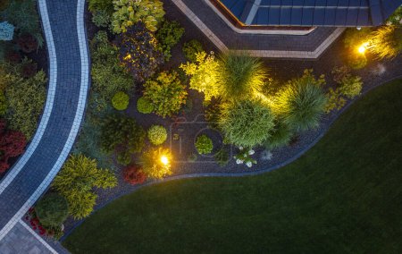 Photo for Elegant Small Residential Back Yard Garden Illuminated by Outdoor Lights Aerial View. - Royalty Free Image
