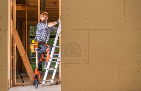 Photo for Professional Construction Contractor Worker Inside Newly Built House Frame - Royalty Free Image