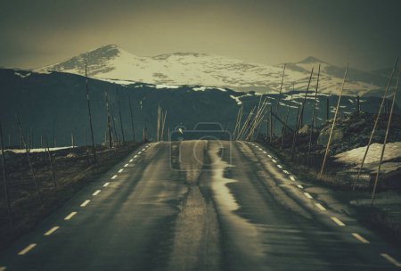 Photo for Norwegian Mountain Road with Side Snowplowing Wooden Poles - Royalty Free Image