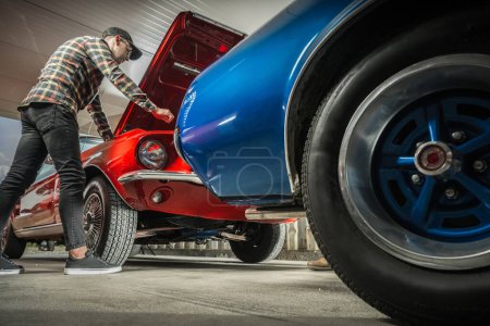 Photo for Caucasian American Classic Cars Enthusiast in His 30s Working on His Vehicle - Royalty Free Image