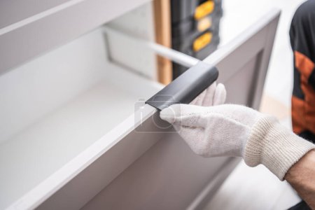 Photo for Caucasian Cabinetmaker Contractor Installing Kitchen Cabinets. Drawer Testing - Royalty Free Image