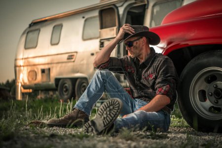 Photo for American Southwest Caucasian Cowboy Next to His Classic Pickup Truck and a Travel trailer - Royalty Free Image