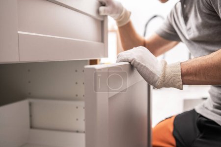 Photo for Caucasian Professional Cabinetmaker Assembling Kitchen Furniture Drawers - Royalty Free Image
