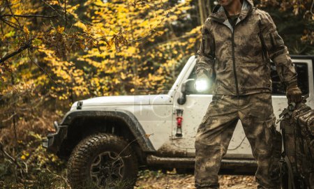 Photo for Off Road Expedition Theme with a Man Wearing Camouflage in Front of His SUV - Royalty Free Image