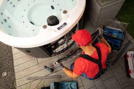 Photo for Caucasian Garden SPA Technician Performing Hot Tub Service Maintenance - Royalty Free Image