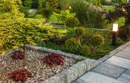 Photo for Elegant Residential Garden Separated by Granite Elements. Landscaping and Gardening Theme. - Royalty Free Image