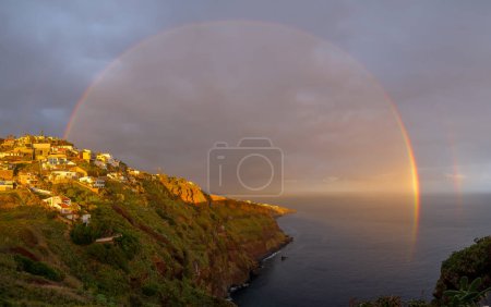 Photo for Landscape with rainbow over Canico at sunset time in Madeira - Royalty Free Image