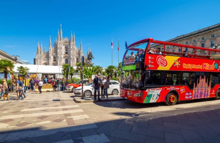 Photo for Milan, Italy - April  27, 2019: Landscape with Duomo di Milano Cathedral and red bus in Milano, Italy - Royalty Free Image