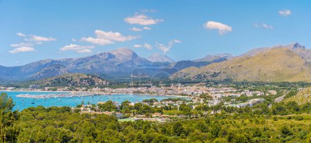 Photo for Panoramic view of Port de Pollena, nestled by the Serra de Tramuntana, with azure waters and a vibrant marina - a gem in Mallorca crown. - Royalty Free Image
