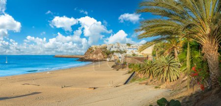 Foto de Pasee por el paseo marítimo bordeado de palmeras de Morro Jable en Fuerteventura, con aguas azules y costas arenosas que ofrecen una tranquila escapada a las Islas Canarias - Imagen libre de derechos
