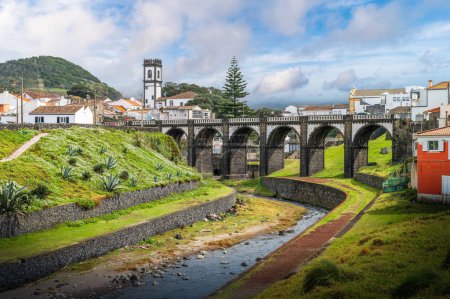 Photo for Explore the charming architecture and natural beauty of Ribeira Grande, Sao Miguel, through this picturesque view of its iconic arch bridge and serene river setting. - Royalty Free Image