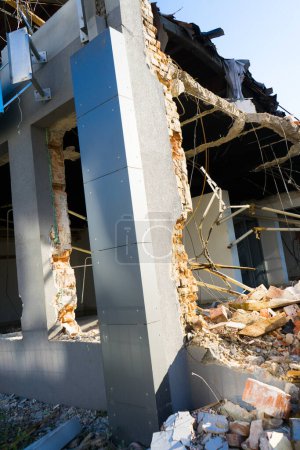 Photo for Construction site digger yellow demolishing house for a reconstruction - Royalty Free Image