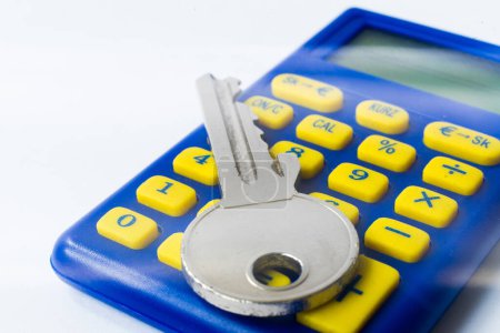 Photo for The calculator and a home key macro closeup, white background - Royalty Free Image