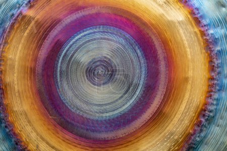 Full frame abstract closeup shot of a colorful metallic asian gong