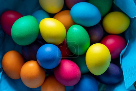 Detail shot of some colorful easter eggs in a basket seen from above