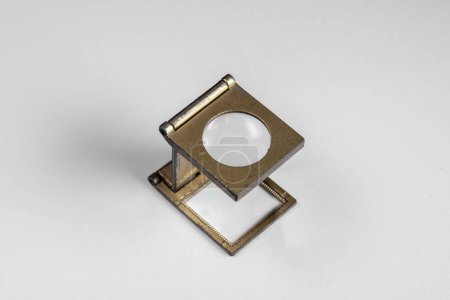 Photo for Old lithographic loupe with metal frame and brass-toned glass lens - Royalty Free Image