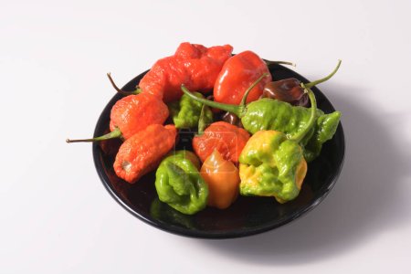 Photo for Chile peppers Capsicum chinense on black plate - Royalty Free Image