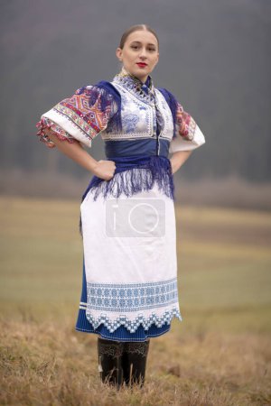 Photo for Young beautiful slovak woman in traditional dress. Slovak folklore - Royalty Free Image