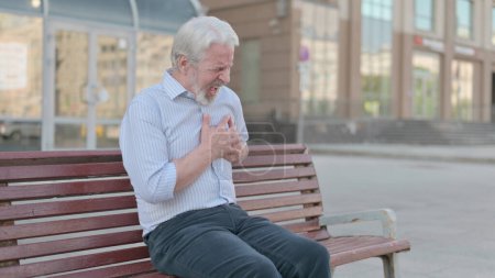Photo for Senior Old Man having Back Pain while Sitting on Bench Outdoor - Royalty Free Image