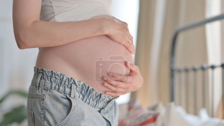 Photo for Close Up of Pregnant Woman Holding Her Big Tummy, Abdomen - Royalty Free Image