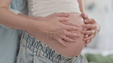 Photo for Close Up of Husband Holding Pregnant Woman Big Belly - Royalty Free Image