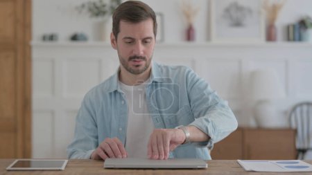 Photo for Casual Man Coming, Sitting and Opening Laptop for Work - Royalty Free Image