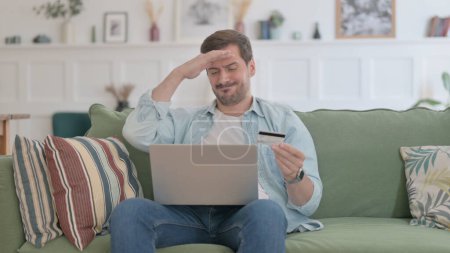 Téléchargez les photos : Casual Man with Unsuccessful Online Payment on Laptop on Sofa - en image libre de droit