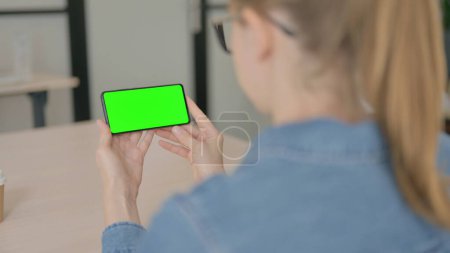 Photo for Beautiful Woman Holding Smartphone with Chroma Key - Royalty Free Image