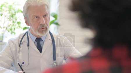 Photo for The Close Up of Old Doctor Talking with Patient in Clinic - Royalty Free Image