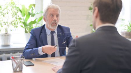 Foto de The Angry Old Businessman Talking with Businessman in Office, Shouting - Imagen libre de derechos