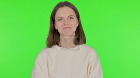 Photo for Approval by Casual Woman Shaking Head on Green Background - Royalty Free Image