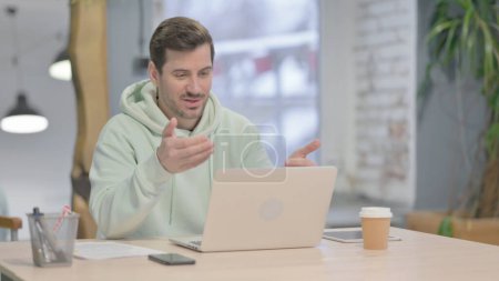 Photo for Young Adult Man Doing Online Video Chat in Office - Royalty Free Image