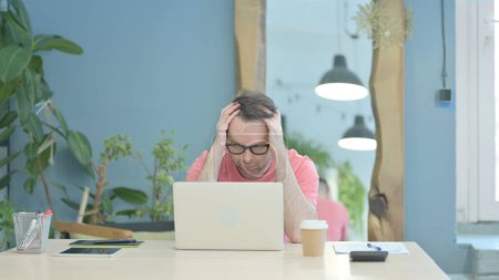 Photo for Creative Senior Old Man Reacting to Loss while using Laptop - Royalty Free Image