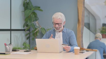 Photo for Senior Old Man Pointing at the Camera While Working on Laptop - Royalty Free Image
