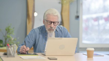 Téléchargez les photos : Senior Old Man Working on Laptop and Documents - en image libre de droit