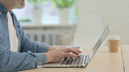 Photo for Side View of Male Hands Typing on Laptop - Royalty Free Image