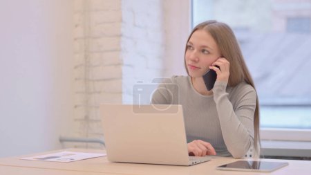 Photo for Creative Young Woman Talking on Phone - Royalty Free Image
