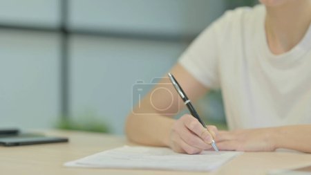 Photo for Close Up of Woman Writing at Work - Royalty Free Image
