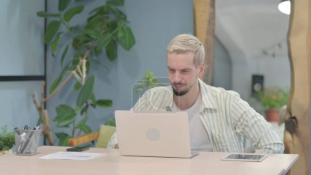 Photo for Modern Young Man Reacting to Loss While Working in Office - Royalty Free Image